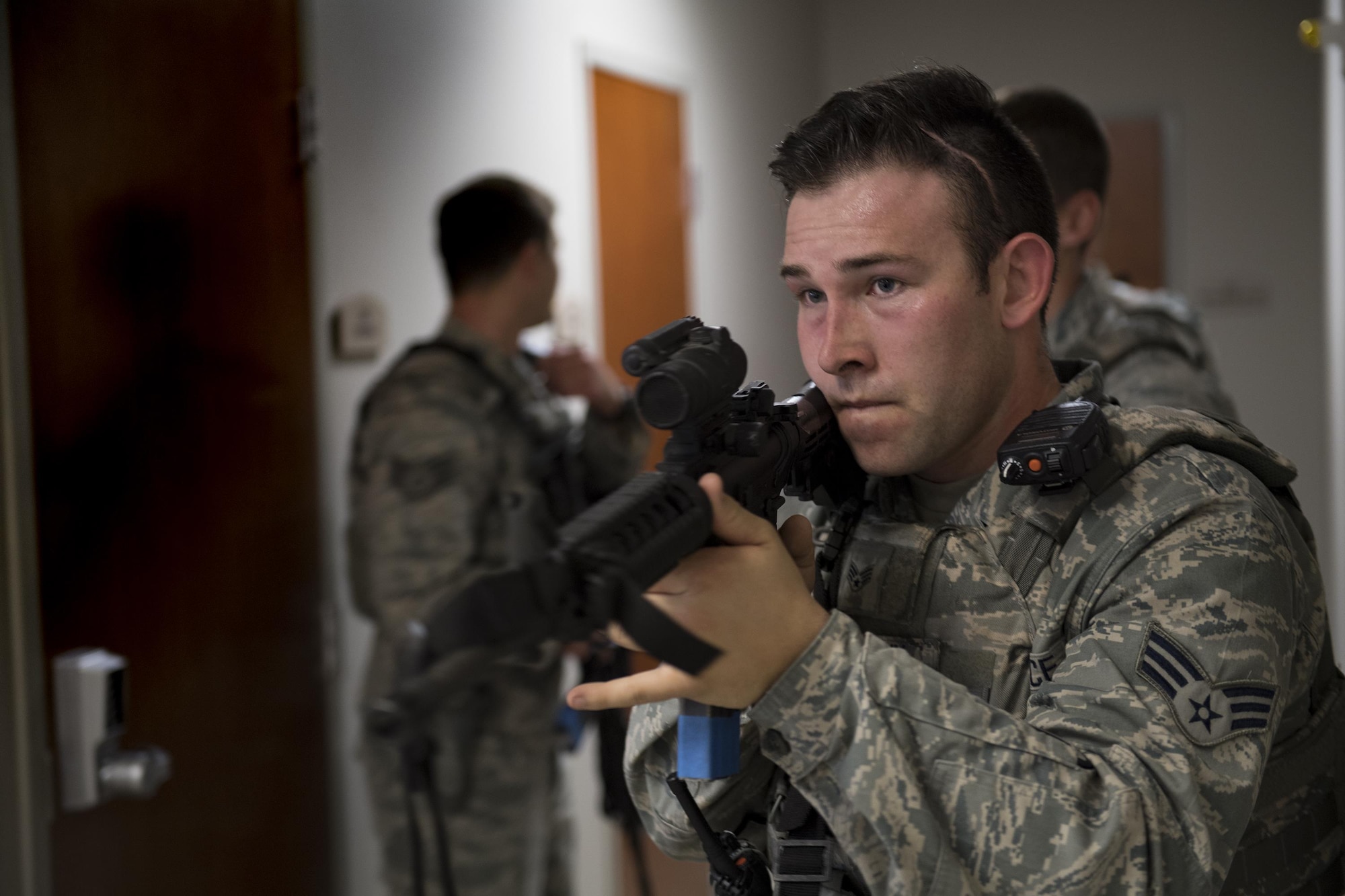 Senior Airman Matthew McFarlin, 23d Security Forces Squadron entry controller, advances down a hallway during an active shooter exercise, Dec. 8, 2016, at Moody Air Force Base, Ga. Members of the 23d SFS systematically moved through the building ensuring no additional threats were present. (U.S. Air Force photo by Airman 1st Class Daniel Snider)