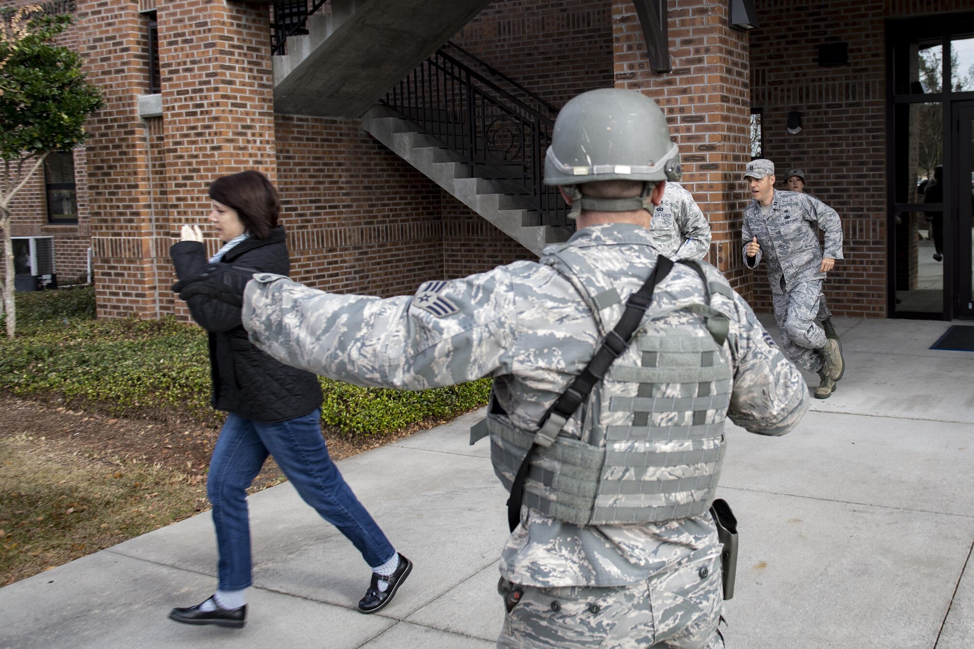 A member of the 23d Security Forces Squadron directs people away from the crime scene during an active shooter exercise, Dec. 8, 2016, at Moody Air Force Base, Ga. After 23d SFS declared the scene safe people were allowed to evacuate the building. (U.S. Air Force photo by Airman 1st Class Daniel Snider)