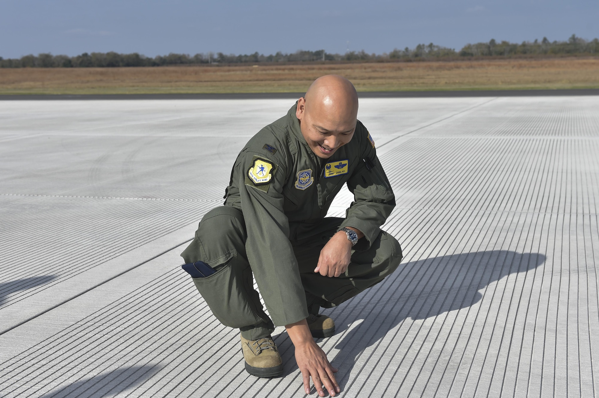 U.S. Air Force Col. Jimmy Canlas, 437th Airlift Wing commander, admires the recent repairs to the North Auxiliary Airfield runway in North, South Carolina Dec. 8, 2016. The runway, originally constructed with asphalt, was deteriorating. 