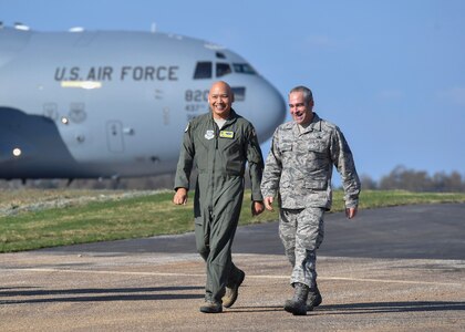 Col. Jimmy Canlas, 437th Airlift Wing (AW) commander, left, and Chief Master Sgt. Kristopher Berg, 437th AW command chief, right, walk down the flightline after getting off a C-17 Globemaster III aircraft at the North Auxilliary Airfield in North, South Carolina, Dec. 8, 2016.The repairs included 21,000 tons of the stone base being recycled before pouring cement and more than 36,000 square yards of asphalt for the shoulders of the landing zone, 66,000 linear feet of wire and new lights were also installed.
