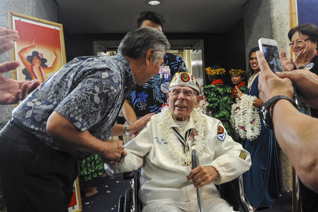 Hawaii Gov. David Ige greets Pearl Harbor survivor and former Army member Alexander Horanzy upon arrival in Honolulu, Dec. 3, 2016. Horanzy was on an honor flight from Los Angeles that carried Pearl Harbor survivors and other veterans to Hawaii for commemorations for the 75th anniversary of the Pearl Harbor attack. DoD photo by Lisa Ferdinando
