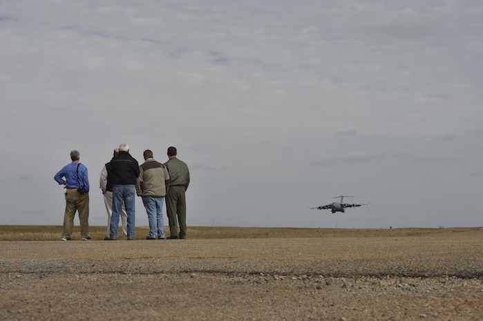 Members of the construction crew watch as the first C-17 Globemaster III lands on the North Auxiliary runway in North, South Carolina Dec. 8, 2016 following a six-month runway construction project. The runway, originally constructed of asphalt, was beginning to deteriorate. Approximately 21,000 tons of asphalt was repurposed as a foundation below the new concrete. 