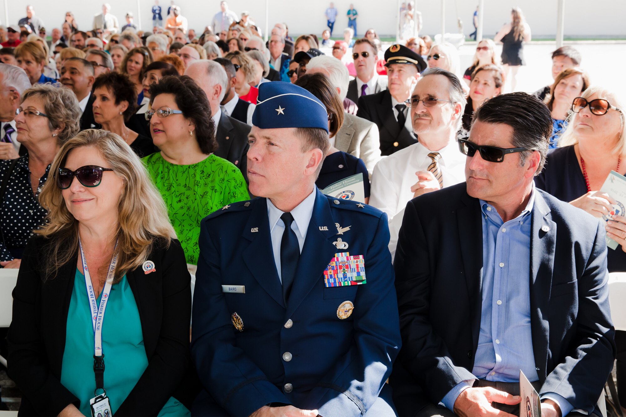 Brig. Gen. Mark Baird, vice commander of the Space and Missile Systems Center at Los Angeles Air Force Base in El Segundo, California, seated with Lana Toenjes, VA Long Beach Fisher House manager, and Drew Hatcher of the Masco Corporation Foundation, listens to remarks by Fisher House Foundation president David Coker during the dedication ceremony Oct. 19 at the VA Long Beach Medical Center. General Baird attended the ribbon-cutting and housewarming of the sixth and newest Fisher House to open in California as a representative of the only active duty military installation within the greater Los Angeles metropolitan area. (Courtesy photo/ VA Long Beach Healthcare System)
