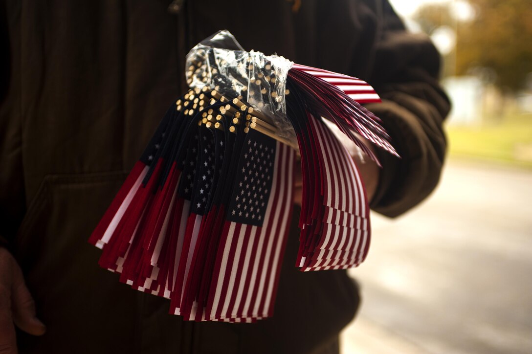 A volunteer holds miniature American flags during the Hero’s Hunt Parade at Santa Fe Park in San Angelo, Texas, Dec. 8, 2016. Multiple volunteers walked the parade path handing out flags for attendees to take and wave to the parade members. San Angelo hosts the Hero’s Hunt Parade for veterans from all over Texas to honor them for their service. (U.S. Air Force photo by Senior Airman Scott Jackson/released)