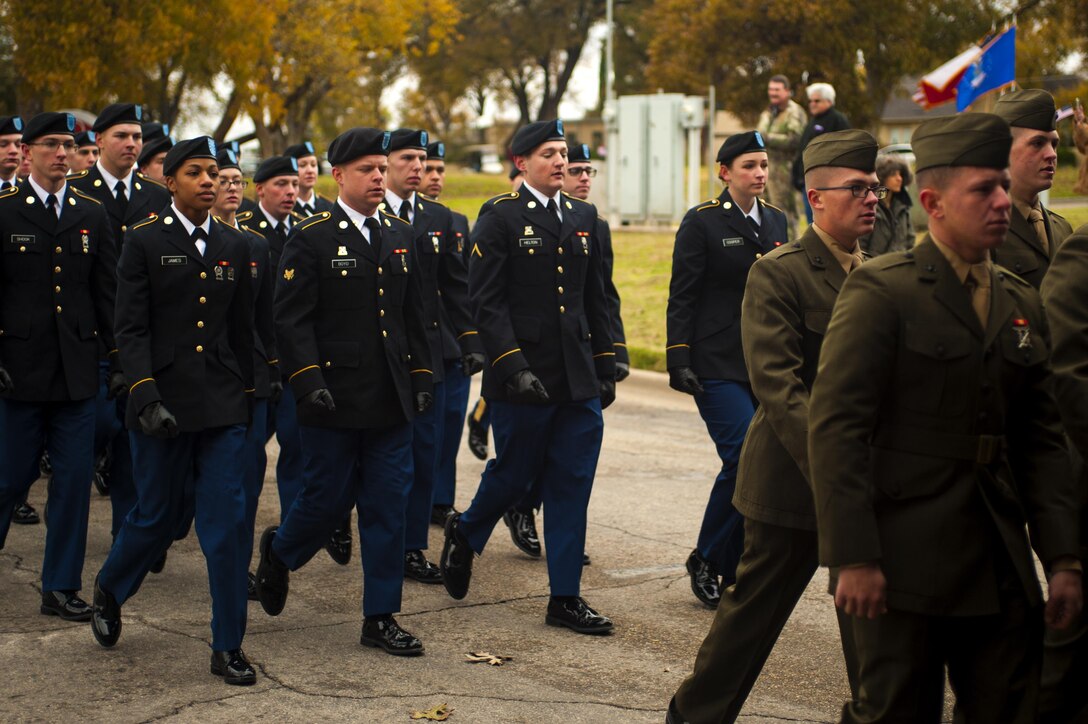 Marines and Soldiers march during the Hero’s Hunt Parade at Santa Fe Park in San Angelo, Texas, Dec. 8, 2016. San Angelo hosts the Hero’s Hunt Parade for veterans from all over Texas to honor them for their service. (U.S. Air Force photo by Senior Airman Scott Jackson/released)