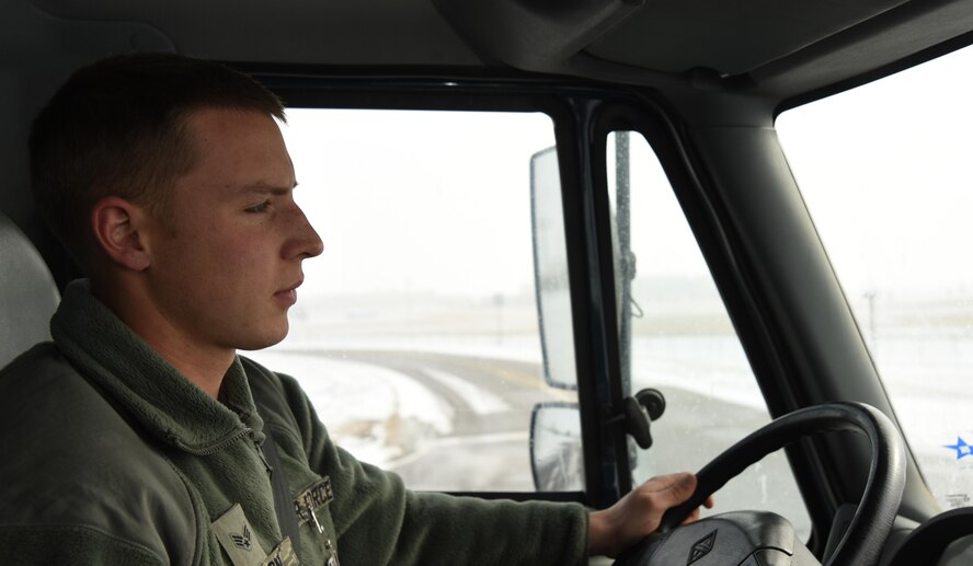 Senior Airman Christopher Anderson, 50th Civil Engineering Squadron, drives his route in a snow plow at Schriever Air Force Base, Colorado, Thursday, Dec. 8, 2016. Anderson and other 50 CES Airman are trained to handle a variety of specialized equipment for use in snowy weather. (U.S. Air Force photo/Airman William Tracy)