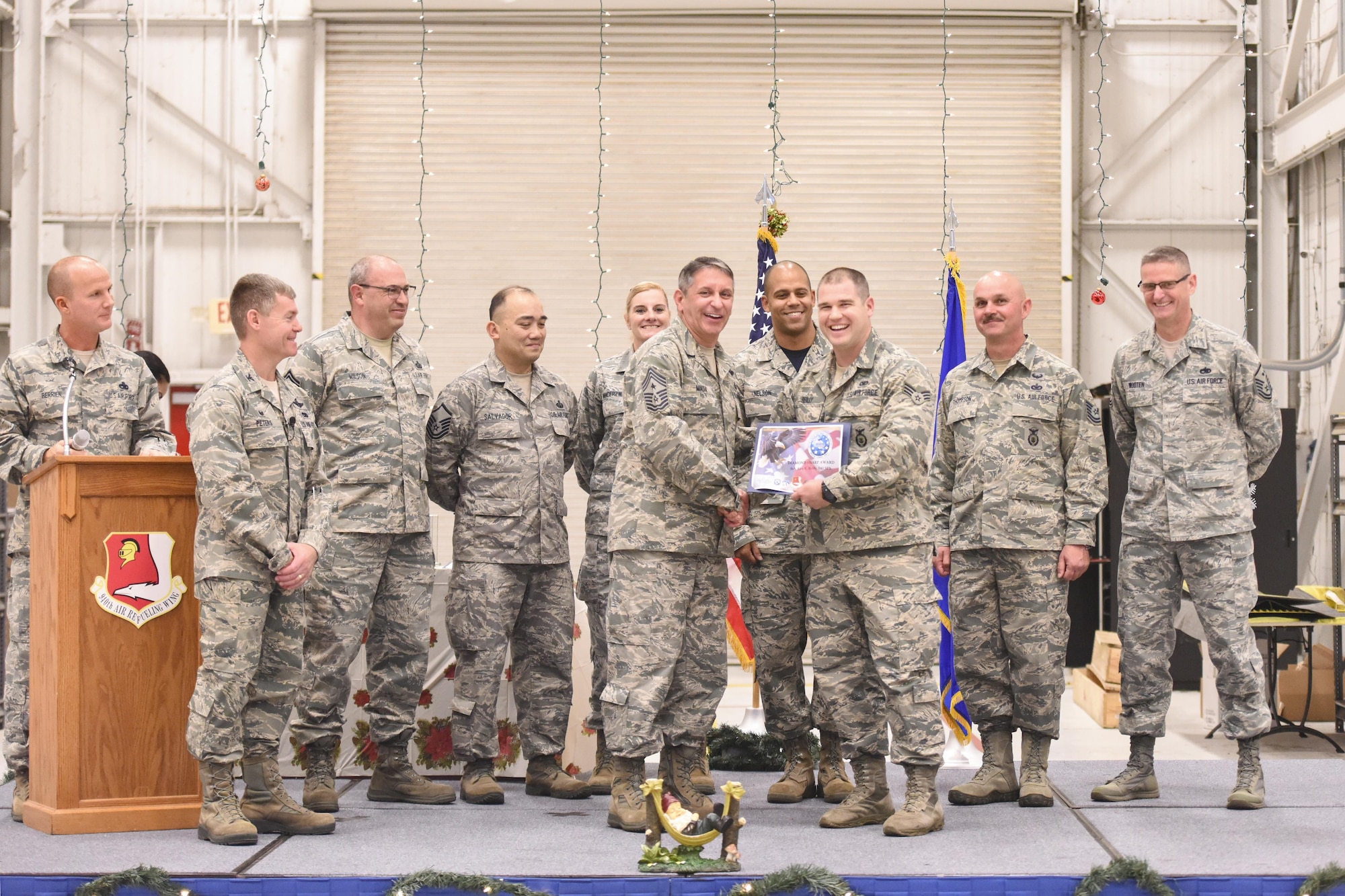 Senior Airman Alex E. Reilly, 940th Security Forces Squadron Fire Team member, is presented with the Diamond Sharp Award by Chief Master Sgt. Carmen Madia, 940th Air Refueling Wing command chief, Dec. 3, 2016, at Beale Air Force Base, California. The Diamond Sharp Award is an award sponsored by the Beale AFB First Sergeants Association to recognize individuals who shines above their peers while making an impact on Airmen and their families. (Air Force Photo by Staff Sgt. Brenda Davis)