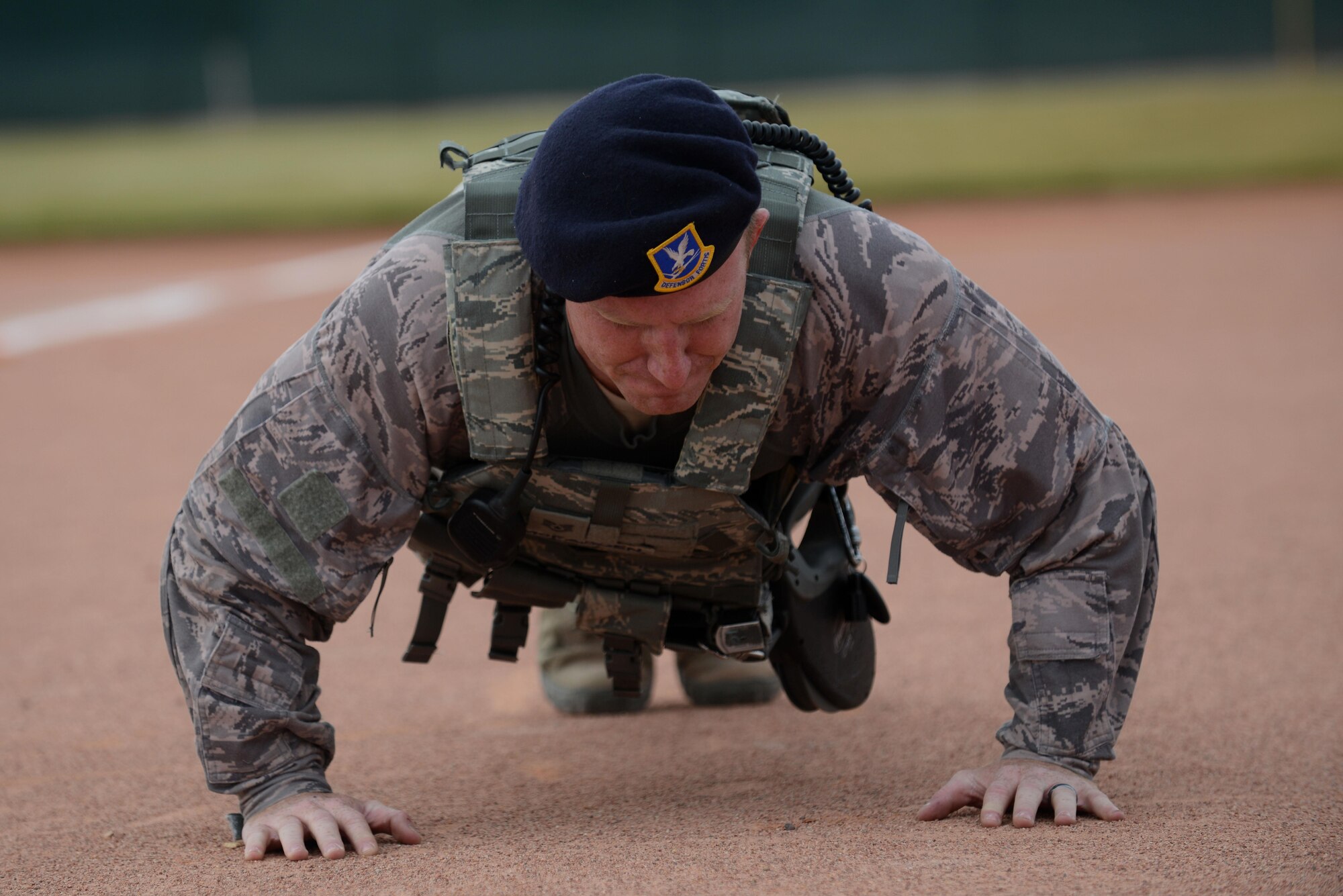 Staff Sgt. Sean Mcfadden, 56th Security Forces Squadron military working dog handler, performs pushups during Luke Winter Games obstacle course Dec. 6, 2016 at Luke Air Force Base, Ariz. The Winter Games is a friendly competition between squadrons to improve moral and comradery. (U.S. Air Force photo by Airman First Class Alexander Cook)