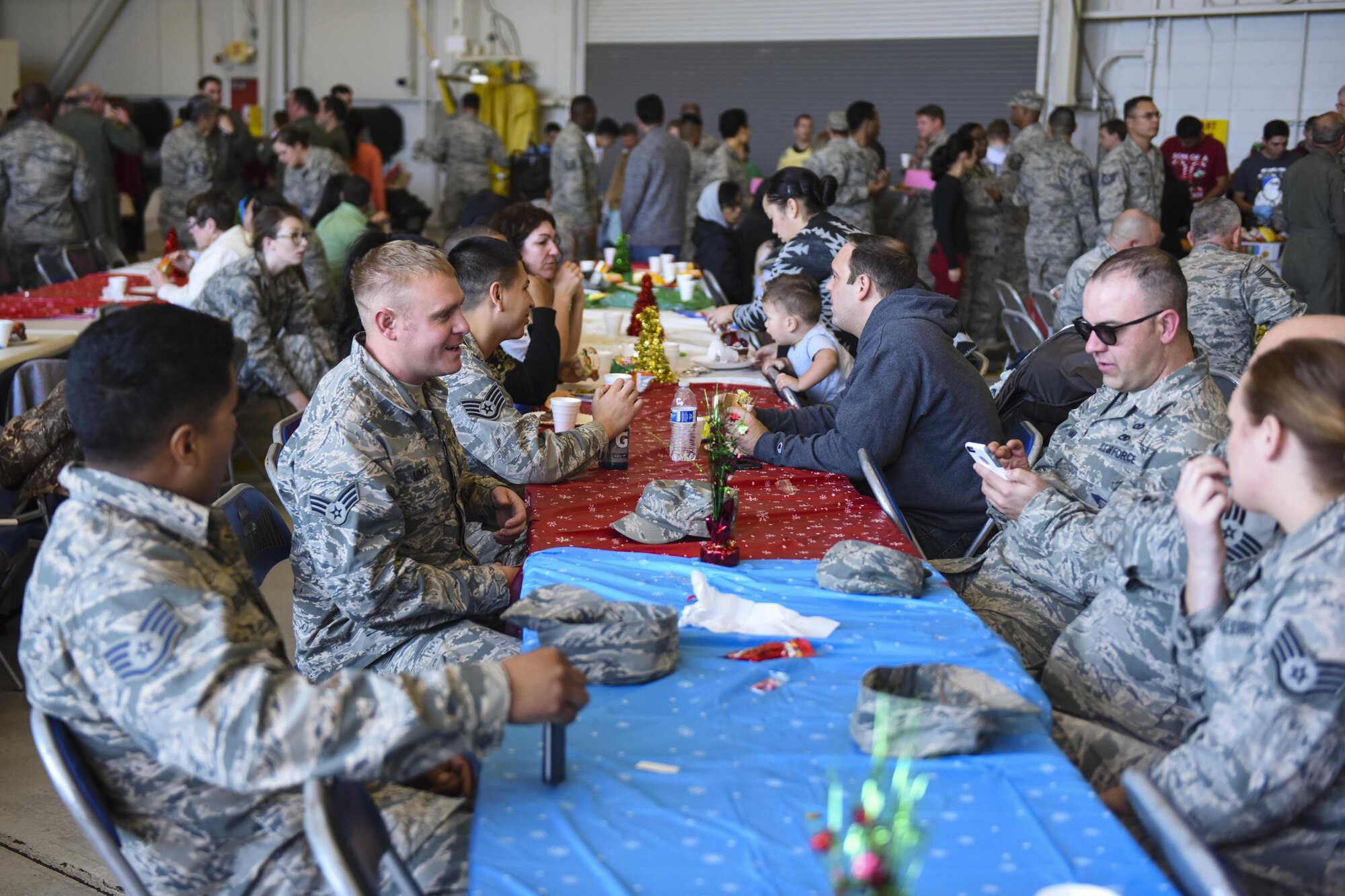 Airmen and their families socialize at the 940th Air Refueling Wing’s holiday party Dec. 3, 2016, at Beale Air Force Base, California. During the party, Airmen and their families were invited to tour the wing’s KC-135 Stratotanker, take photos with Santa, eat and win prizes. (Air Force Photo by Staff Sgt. Brenda Davis)