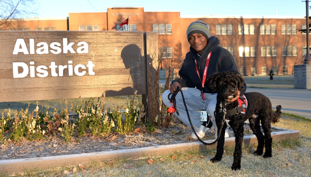 A native of Mountain Pine, Arkansas, Erik Babb, procurement technician in the Contracting Division, received Matai (mah-TIE’), a Portuguese water dog, at no cost from 832 K9’s Deputy Dogs, a Florida-based nonprofit group. The organization specializes in providing law enforcement agencies across the nation and Europe with trained bloodhounds to assist in searching for missing persons and during other life-saving events. 