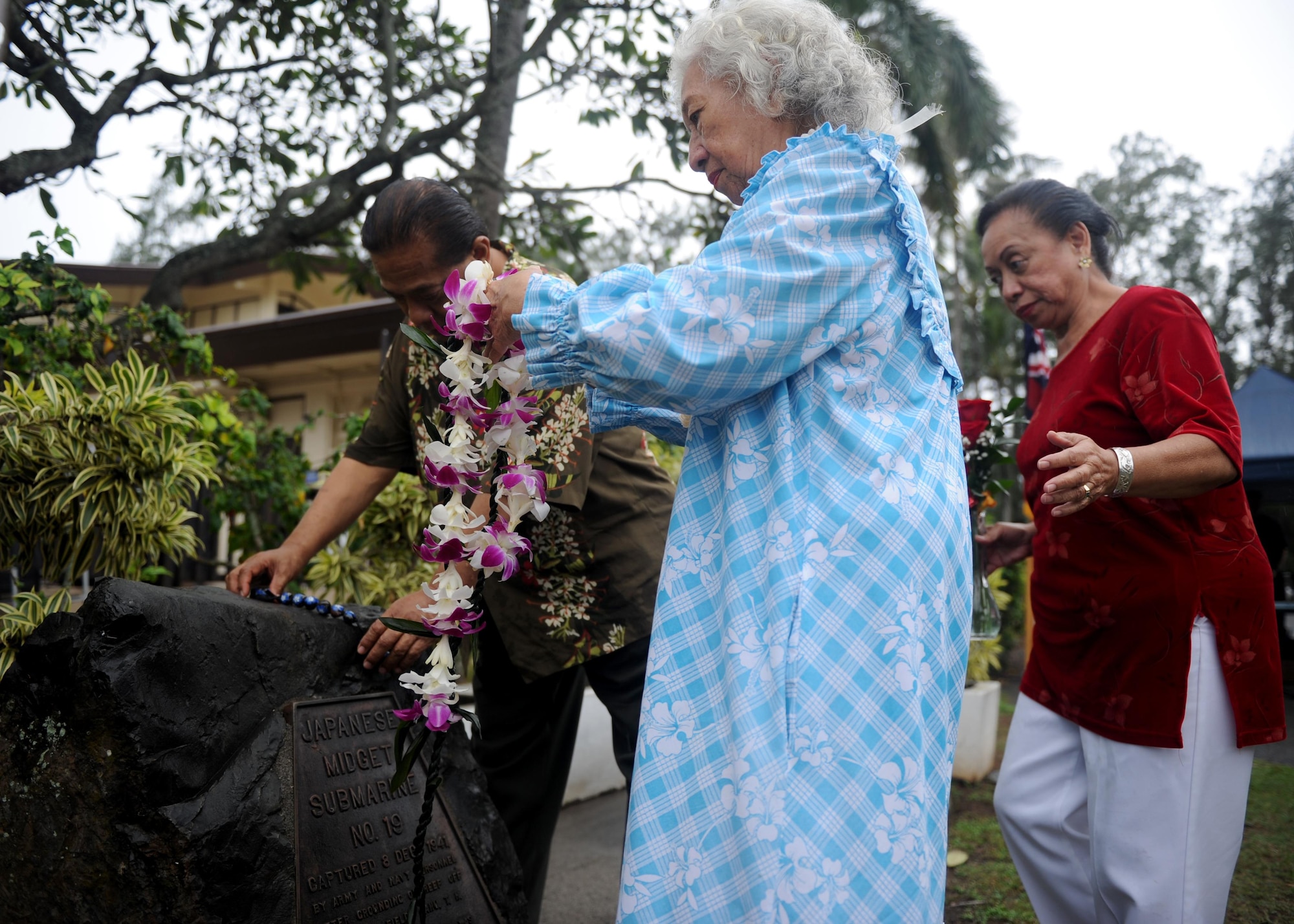 Family members of an honored veteran present leis on a memorial during a commemoration ceremony at Bellows Air Force Station, Hawaii, Dec. 8th, 2016. Approximately 100 people, including family members of several honored veterans, came together in recognizing the bravery displayed at Bellows during the Dec. 7th attack on Pearl Harbor and Oahu. (U.S. Air Force photo by Staff Sgt. Alexander Martinez)