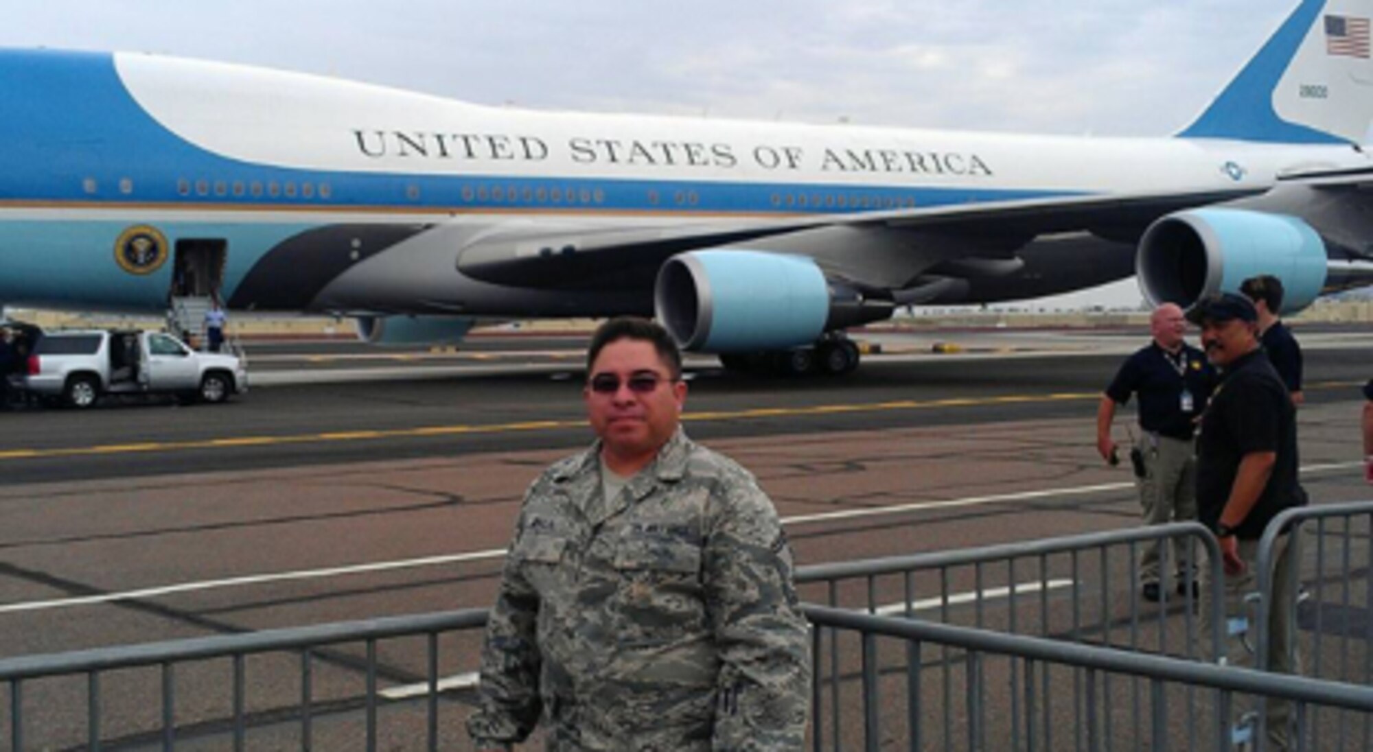 Courtesy photo of retired Senior Master Sgt. Hector Baca, Jr. posing for a photo in front of Air Force One.