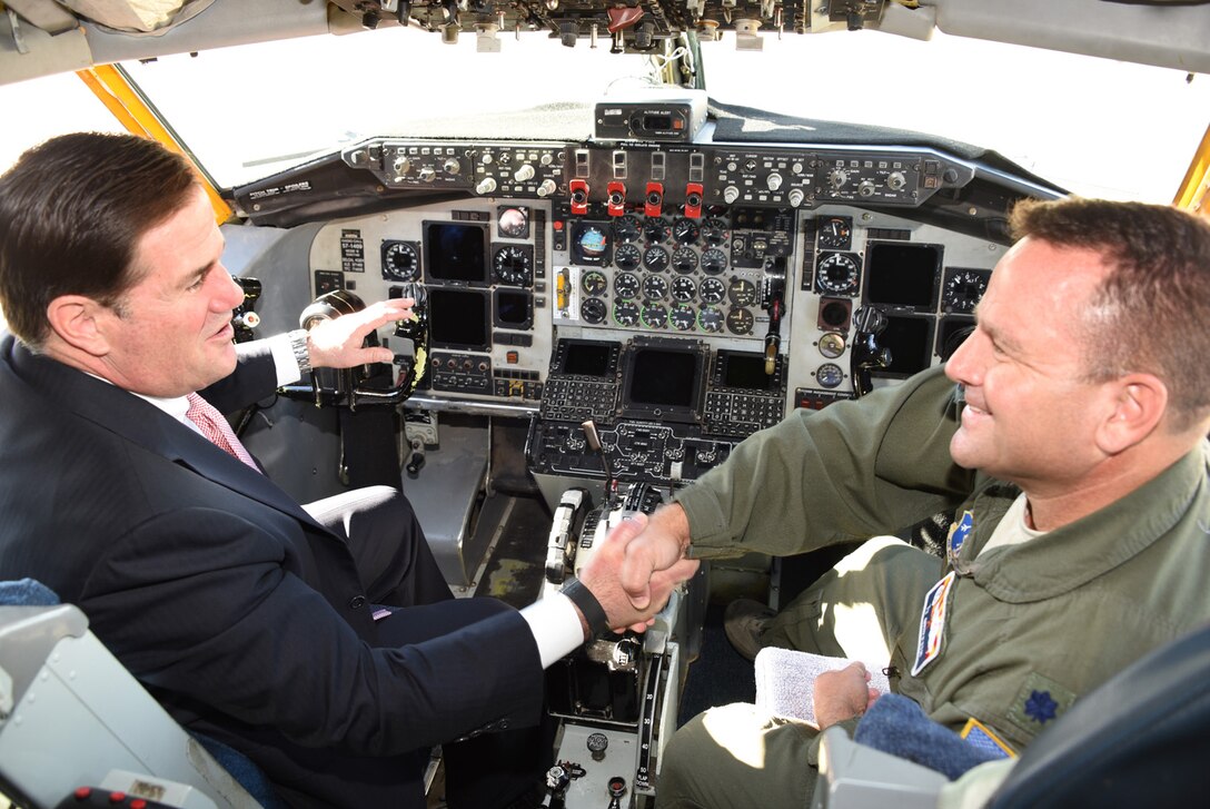 Gov. Doug Ducey shakes hands with Lt. Col. Tyler Griffith, commander of the 197th Air Refueling Squadron in the cockpit of a KC-135 Stratotanker aircraft, Dec 9, 2016. Ducey was touring the aircraft during the Goldwater Air National Guard Base name dedication ceremony.(U.S. Air National Guard photo by Technical Sgt. Michael Matkin) 