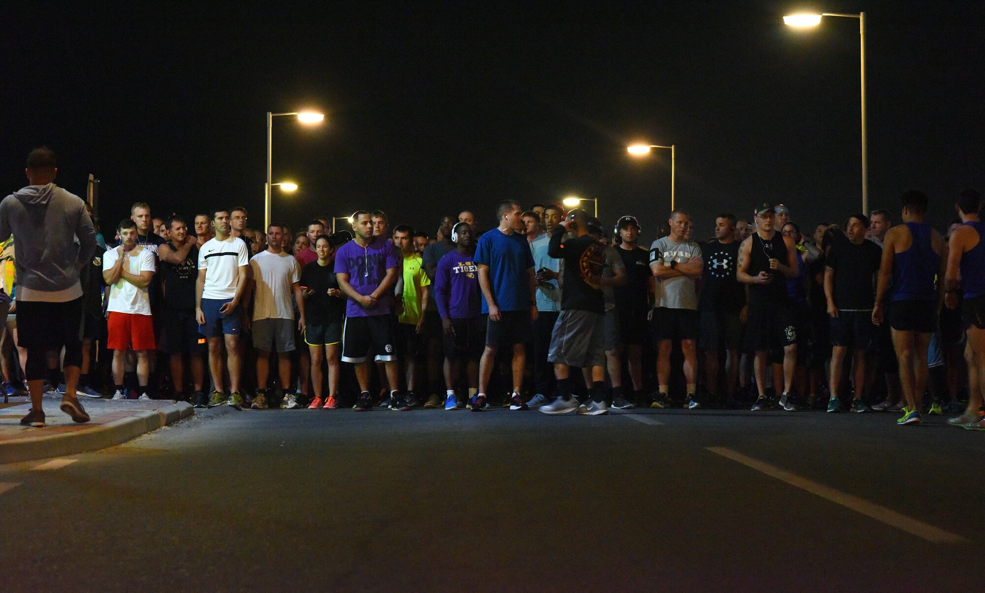 Base personnel fill the starting line of a 5K race commemorating the 75th anniversary of the attack on Pearl Harbor at Al Udeid Air Base, Qatar, Dec. 7, 2016. Participants used the anniversary as an opportunity to come together and honor the sacrifice and dedication of those who perished and those who survived the attack, both civilian and military. (U.S. Air Force photo by Senior Airman Cynthia A. Innocenti)