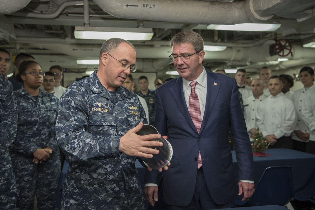 Defense Secretary Ash Carter meets with Navy Capt. Chris DeGregory, commanding officer of the USS Monterey, while the ship is in port in Manama, Bahrain.
