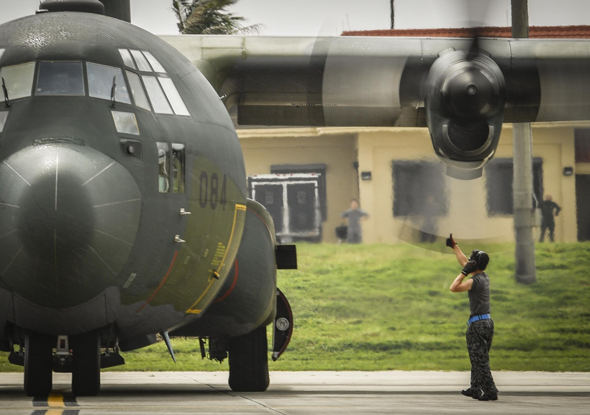 A maintainer with the Japan Self Defense Force communicates with the air crew of a C-130H Hercules before takeoff at Andersen Air Force Base, Guam, Dec. 7, 2016. C-130 Hercules air crews and maintainers came to Andersen from Yokota Air Base, JASDF and the Royal Australian Air Force to train together by delivering 140 parachute bundles of donated supplies to the Micronesian Islands. (U.S. Air Force photo by Senior Airman Elizabeth Baker/Released)