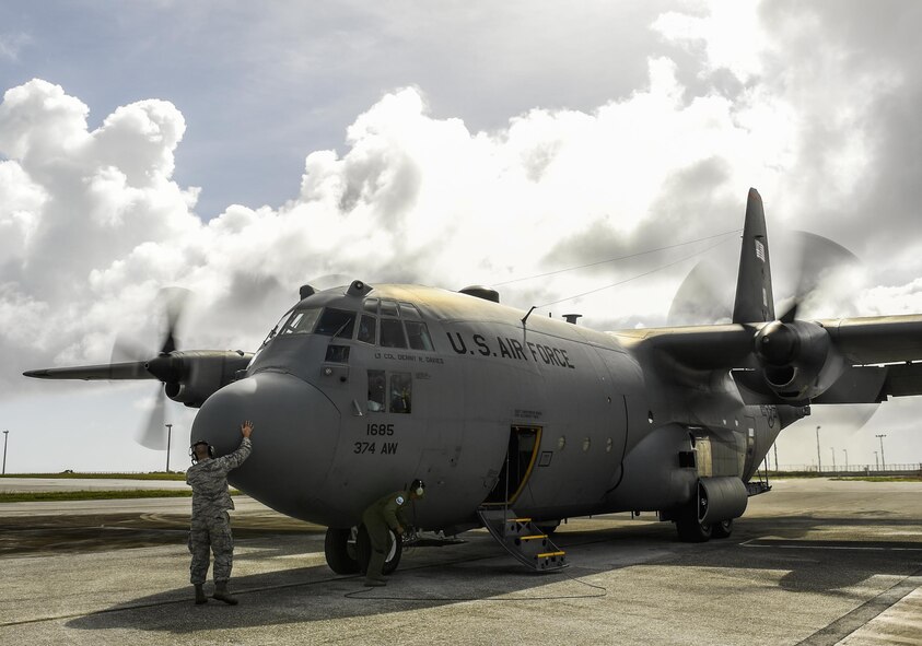 Master Sgt. Christopher Mace, 374th Aircraft Maintenance Squadron crew chief, gives a nose pat to a C-130 H Hercules before takeoff during Operation Christmas Drop at Andersen Air Force Base, Guam, Dec. 7, 2016. C-130s are ideal for performing air drops like those conducted during OCD because they are large enough to carry cargo and small enough to maneuver at relatively low altitudes. (U.S. Air Force photo by Senior Airman Elizabeth Baker/Released)