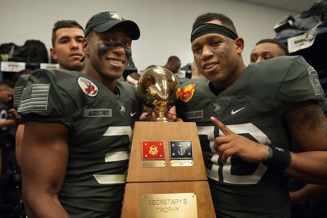 Army running backs Jordan Asberry, left, and Elijah St. Hilaire pose with the Secretary’s Trophy after the Army’s 21-17 victory over the Navy team in Baltimore, Dec. 10, 2016. Army photo by John Pellino