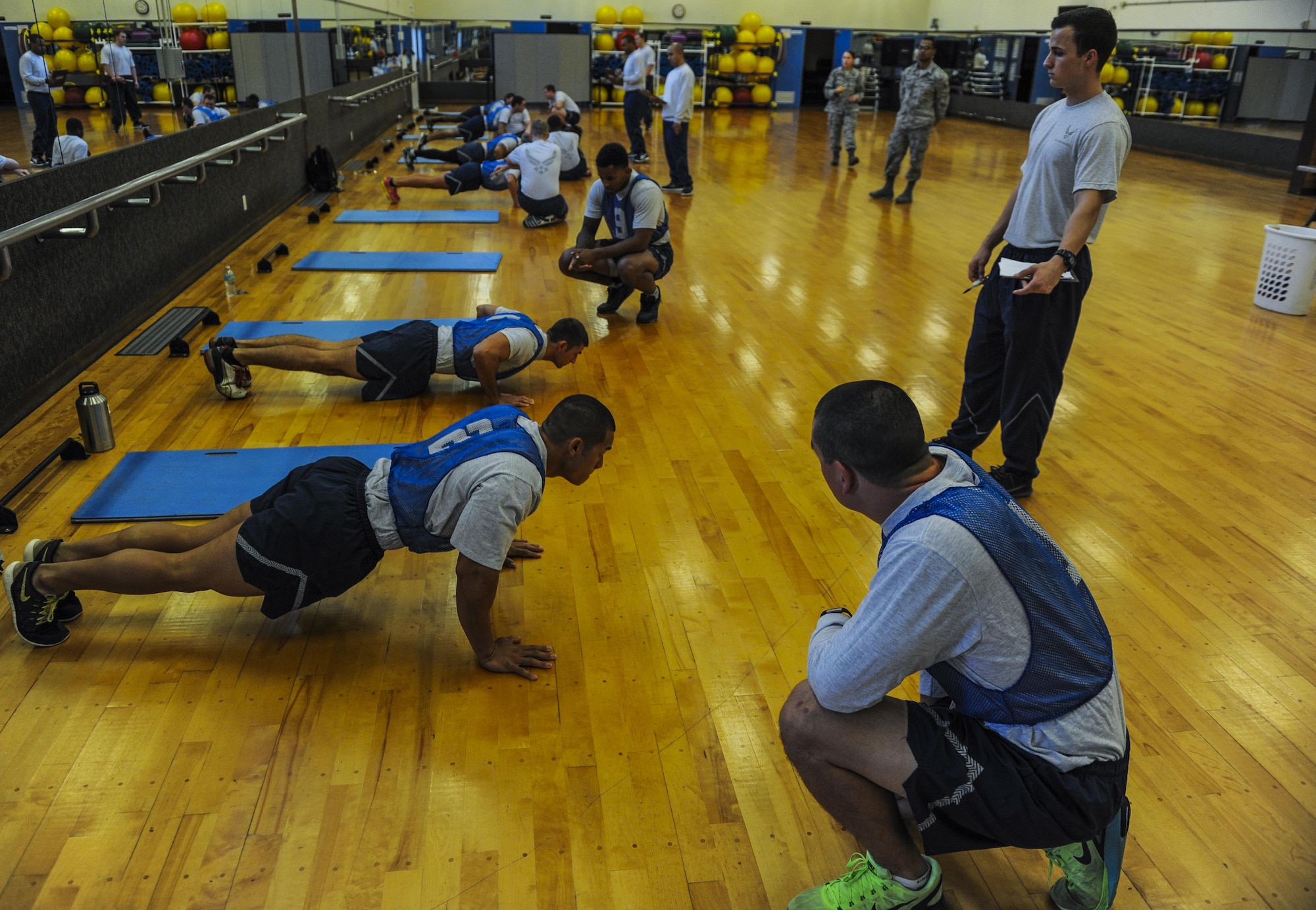 U.S. Air Force Airmen perform the push up portion of the physical fitness test, Dec. 1, 2016, at the Risner Fitness Center on Kadena Air Base, Japan. Proper physical fitness is an integral part of the fit-to-fight mentality as well as part of a healthy lifestyle. (U.S. Air Force photo by Airman 1st Class Nick Emerick/Released) 