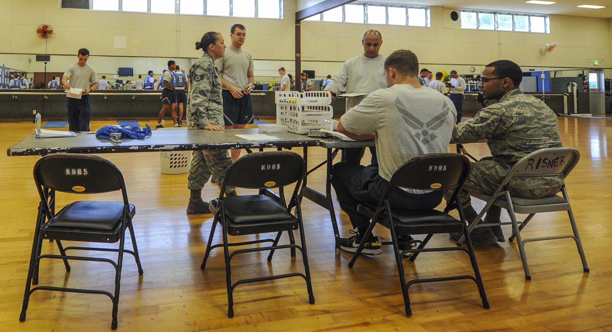 U.S. Air Force physical training leaders and members of the fitness assessment cell score physical fitness tests, Dec. 1, 2016, at the Risner Fitness Center on Kadena Air Base, Japan. The PTLs not only help conduct fitness testing, but also conduct regular physical training sessions at unit and squadron levels. (U.S. Air Force photo by Airman 1st Class Nick Emerick/Released)