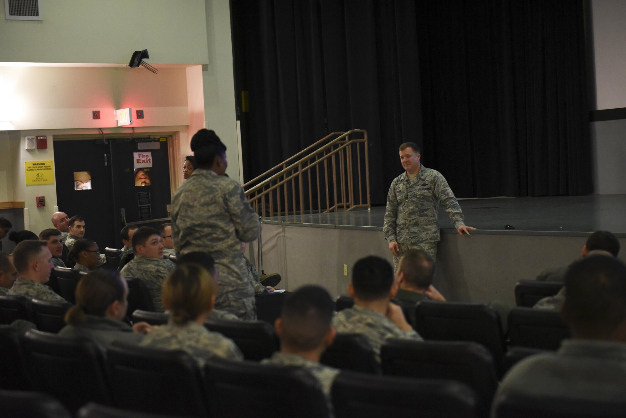 Col. Todd Dozier, 8th Fighter Wing commander, takes questions during an all call during an all call at Kunsan Air Base, Republic of Korea, Dec. 9, 2016. Dozier hosted an all call and provided answers to airmen with questions regarding base operations. (U.S. Air Force photo by Senior Airman Michael Hunsaker/Released)