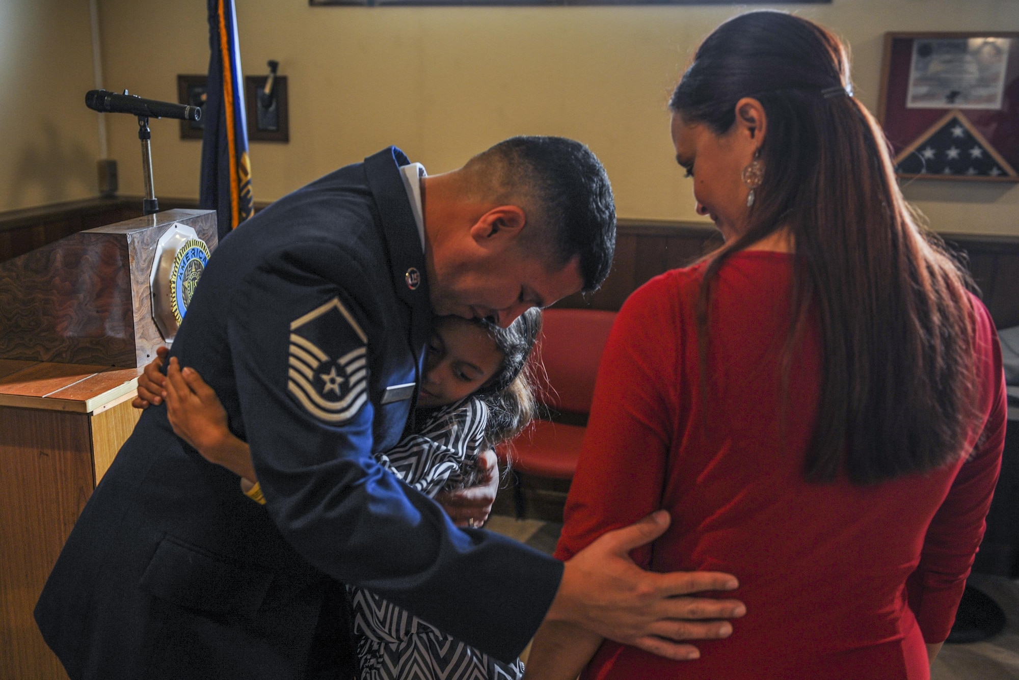 U.S. Air Force Master Sgt. Thundercloud Hirajeta with his wife April and daughter Autumn following his reenlistment, Dec. 2, 2016 at the American Legion Wayne E. Marchand post on Okinawa, Japan. He was sworn in by retired United States Marine Corps Maj. John Glenn, who had been his Junior Reserve Officers' Training Corps instructor. (U.S. Air Force photo by Airman 1st Class Nick Emerick/Released)