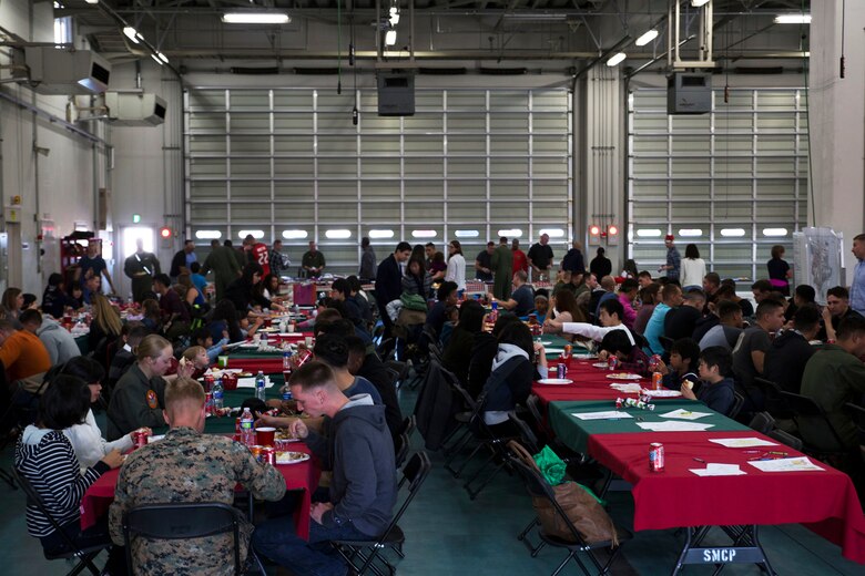 U.S. Marines with Aircraft Rescue and Firefighting, and their families sit together with Japanese locals from ARFF Tsuta Orphanage for a Christmas dinner at Marine Corps Air Station Iwakuni, Japan, Dec. 10, 2016. ARRF holds a Christmas party every year to help spread Christmas cheer to the orphans, and to bring service members, their families and the Japanese together. Marines volunteered their time and provided the children with a homemade, American meal.  (U.S. Marine Corps photo by Lance Cpl. Gabriela Garcia-Herrera)