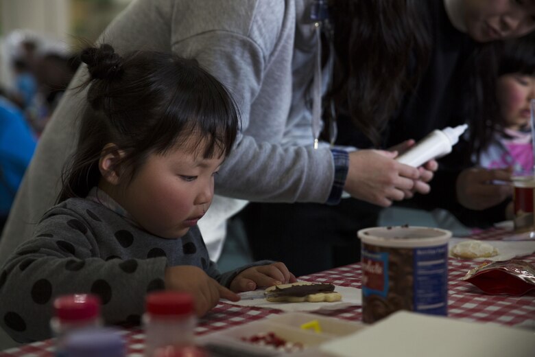 May Yamane, a child from the local orphanage, decorates Christmas cookies at the ARFF Tsuta Orphanage Christmas party at Marine Corps Air Station Iwakuni, Japan, Dec. 10, 2016. ARFF holds the celebration annually to help spread holiday cheer to the orphans and to bring service members, their families and Japanese together. Activities such as a bouncy house, Christmas cookie decorating, and games were available to the children during the party. (U.S. Marine Corps photo by Lance Cpl. Gabriela Garcia-Herrera)