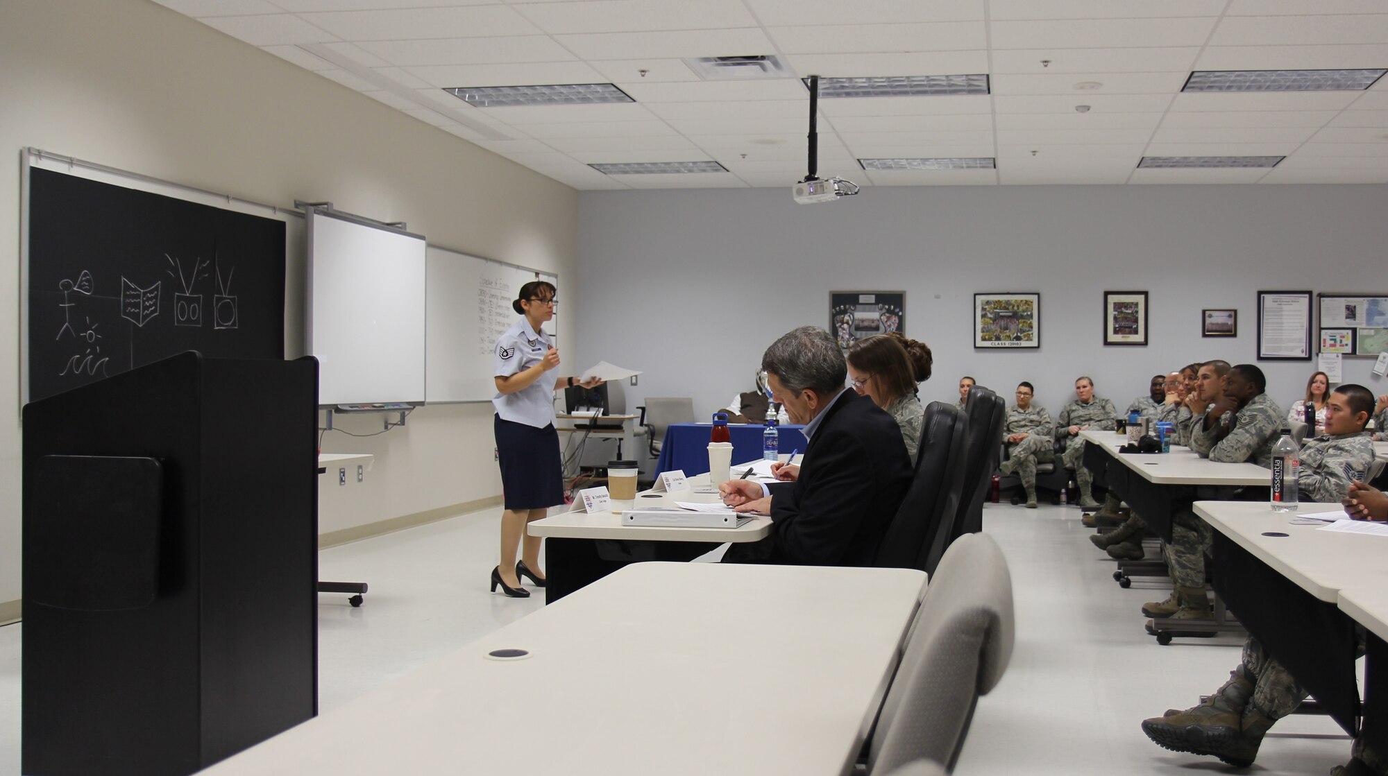 Staff Sgt. Barbara Rucker, an instructor in the United States Air Force School of Aerospace Medicine's Occupational and Environmental Health Department, presents a portion of her team's lesson to the judges at the third annual SAM-Tastic instructional excellence competition. (U.S. Air Force photo/David Snedigar)