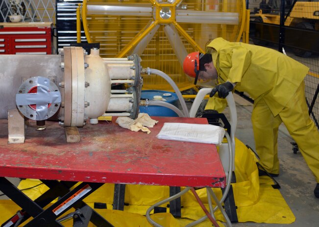 Petty Officer 3rd Class Michael Mulraney uses a readily available "off the shelf" industrial liquid descaler to clean a close3d-loop heat exchanger at Southeast Regional Maintenance Center (SERMC). Upon completion, the descaling solution is pH neutralized and properly disposed of by SERMC's Hazardous Waste Coordinator,