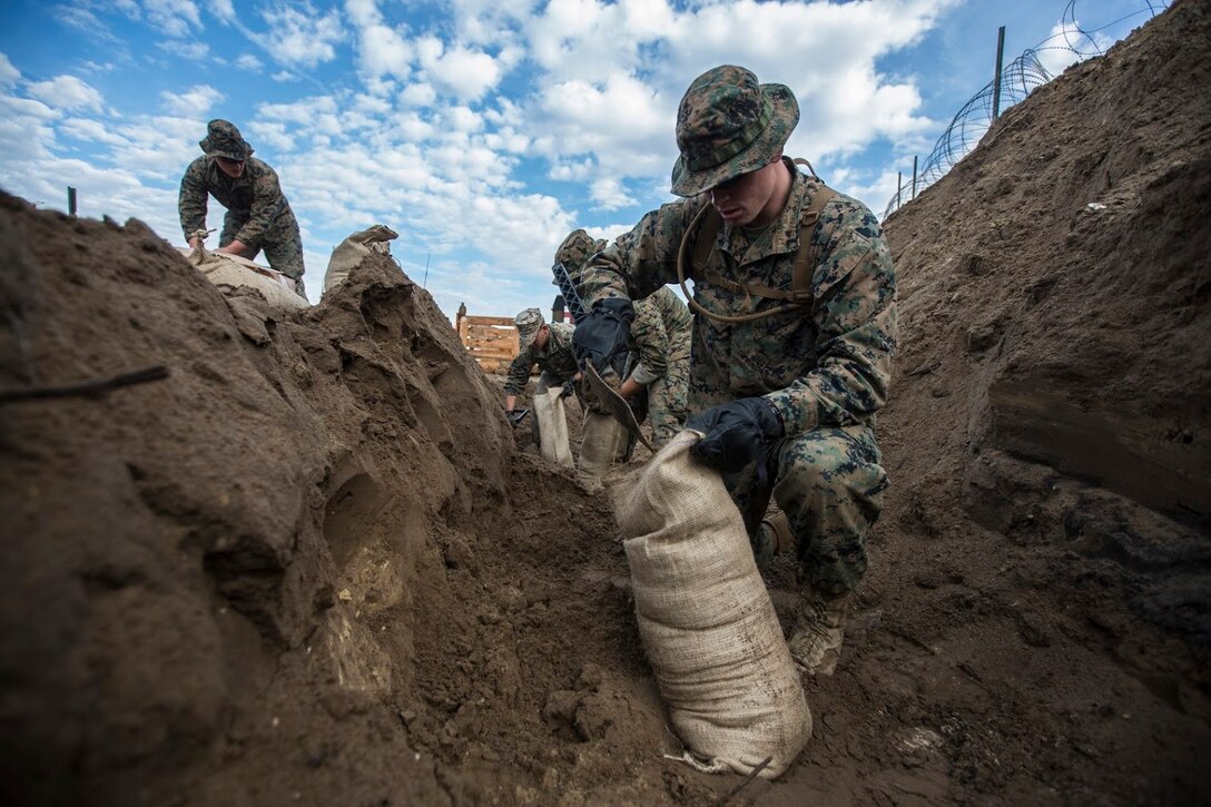 Marines assigned to Marine Wing Support Squadron 271, Marine Aircraft Group 14, 2nd Marine Aircraft Wing fill sand bags during a field exercise aboard Marine Corps Auxiliary Landing Field Bogue, N.C., Nov. 30, 2016. MWSS-271 conducted a two-week field exercise that focused on maintaining the squadron’s expeditionary mindset and included an evaluation by the Marine Corps Combat Readiness Evaluation system. (U.S. Marine Corps photo by Sgt. N.W. Huertas/ Released) 