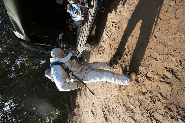 Lance Cpl. Brandon Black puts on his gear during a timed response drill aboard Marine Corps Auxiliary Landing Field Bogue, N.C, Nov. 30, 2016. Aircraft firefighting and rescue specialists assigned to Marine Wing Support Squadron 271, Marine Aircraft Group 14, 2nd Marine Aircraft Wing, participated in a two-week field exercise conducted by the squadron. The AARF Marines’ ability to be at the scene of a mishap is timed down to the second during training evolutions like as this to measure their readiness in responding to real world catastrophes. Black is an aircraft firefighting and rescue specialist assigned to MWSS-271. (U.S Marine Corps photo by Sgt. N.W. Huertas/ Released)