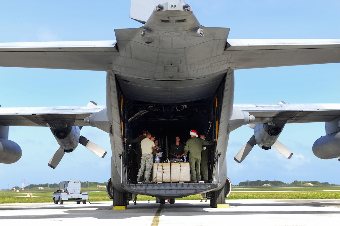 Air Force airmen receive a mission brief aboard a C-130 Hercules during Operation Christmas Drop at Andersen Air Force Base, Guam, Dec 5, 2016. The airmen are assigned to the 36th Airlift Squadron. Air Force photo by Senior Airman Elizabeth Baker