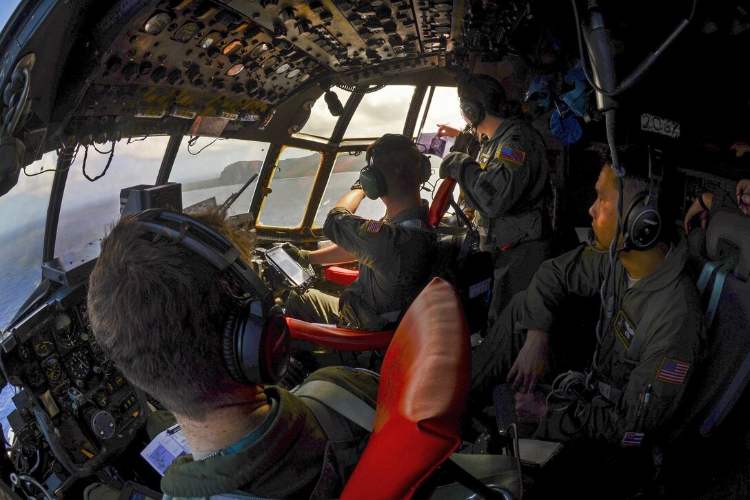 Air Force pilots and crew chiefs aboard a C-130 Hercules circle over the Micronesian islands during Operation Christmas Drop, Dec. 5, 2016. Air Force photo by Senior Airman Elizabeth Baker