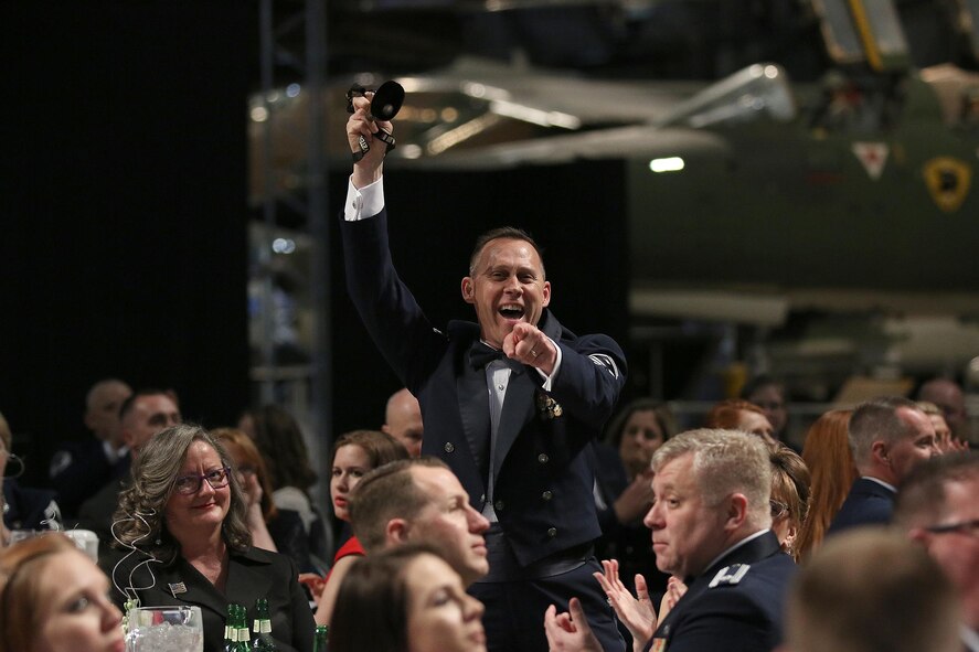 Senior Master Christopher Williams, 87th Aerial Port Squadron First Shirt, celebrates and cheers with a cow bell during the 445th Airlift Wing’s 2016 Annual Award ceremony held April. 2, 2016 at the National Museum of the U.S. Air Force. More than 500 wing members and family members attended the event. (U.S. Air Force photo /Tech. Sgt. Patrick O’Reilly)