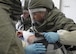 U.S. Air Force Airman 1st Class Chris Stangl, right, a public health technician, and Senior Airman Dylan Kielcheski, an aerospace medical technician, both with the 509th Medical Operations Squadron, help hold a volunteer victim on their side to decontaminate all areas of the victim during a total force mass casualty exercise at Whiteman Air Force Base, Mo., Dec. 3, 2016. Volunteer victims were brought through a decontamination line before being admitted into the clinic. (U.S. Air Force photo/Senior Airman Missy Sterling)