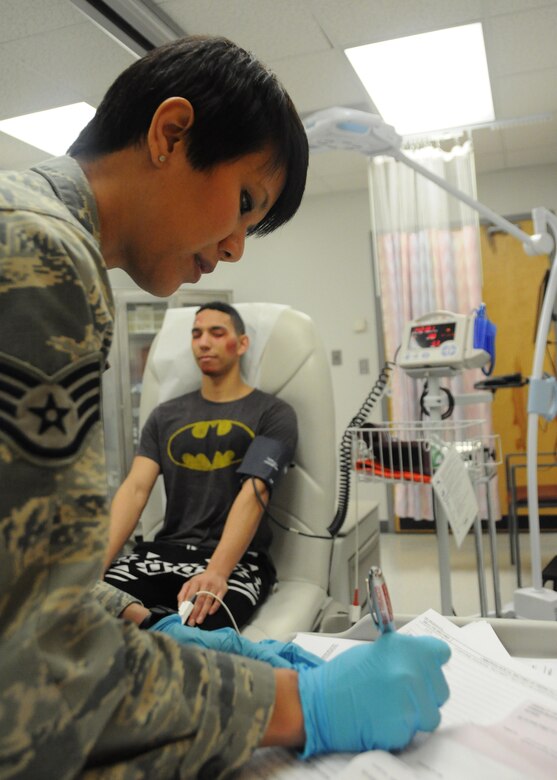 A volunteer victim gets his vitals checked by a 509th Medical Operations Squadron member during a total force mass casualty exercise at Whiteman Air Force Base, Mo., Dec. 3, 2016. Volunteer victims acted-out injuries ranging from no physical harm to severe burns and severed limbs. (U.S. Air Force photo/Senior Airman Missy Sterling)