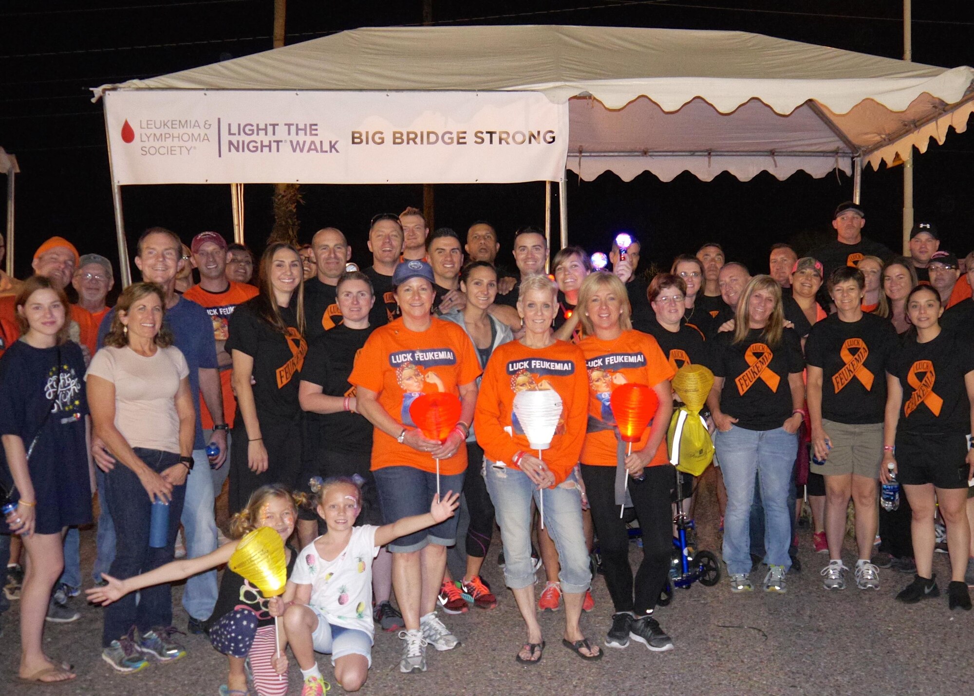 Bridget Alcocer, mother of Tech. Sgt. Francisco Alcocer, 944th Security Forces Squadron combat arms NCO-in-charge, and Airmen from the 944 SFS, participate in a group photo during the Light the Night walk event Nov. 5 to help raise money for the Leukemia Lymphoma Society in Phoenix, Ariz. (Courtesy photo)