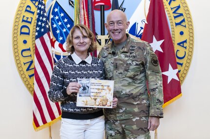 Chief Warrant Officer 5 Pamela Null, U.S. Army Reserve Command G-4, is presented her third place award for her cubicle decoration by LTG Charles D. Luckey, Chief, U.S. Army Reserve and Commanding General, U.S. Army Reserve Command, smiles after lighting the Christmas tree during the USARC Holiday Open House and Tree Lighting ceremony, Dec. 9, 2016. USARC Soldiers and civilians took time out to celebrate the season and fellowship with each other. (U.S. Army photo by Timothy L. Hale/Released)