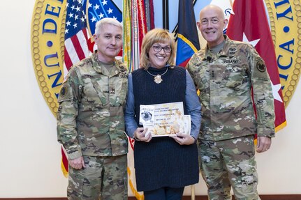 Chief Warrant Officer 5 William Kail, U.S. Army Reserve Command Aviation Directorate, and his wife, Elizabeth, are presented the second place award for his cubicle decoration by LTG Charles D. Luckey, Chief, U.S. Army Reserve and Commanding General, U.S. Army Reserve Command, smiles after lighting the Christmas tree during the USARC Holiday Open House and Tree Lighting ceremony, Dec. 9, 2016. USARC Soldiers and civilians took time out to celebrate the season and fellowship with each other. (U.S. Army photo by Timothy L. Hale/Released)