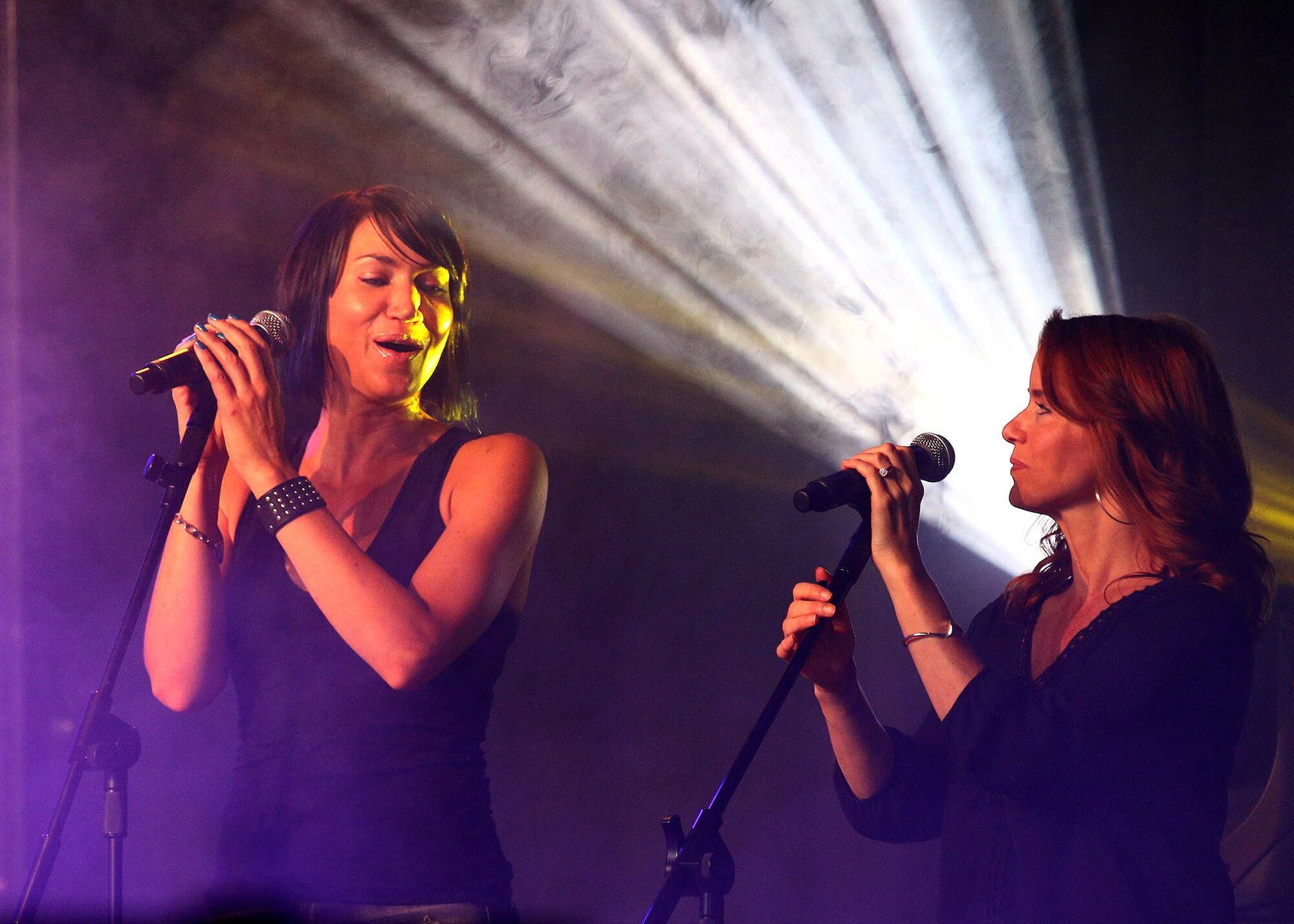 Molly Callinan and Julie Dutchak-Durango, vocals from Lt Dan Band, perform for an early Independence Day celebration held July 2, 2016 at the 445th Airlift Wing Hangar 4016. Gary Sinise and his Lt. Dan Band performed more than 30 shows in 2016, mostly for military and veterans events. (U.S. Air Force photo /Tech. Sgt. Patrick O’Reilly)