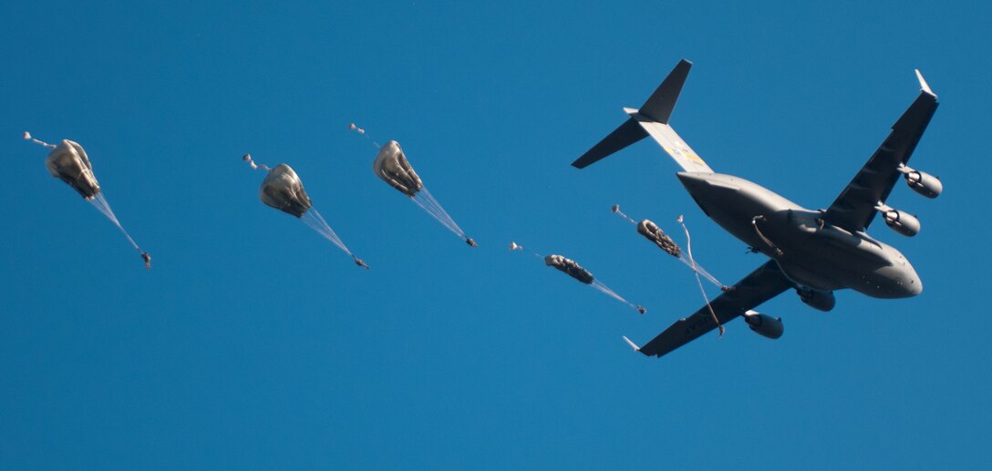 U.S. and foreign paratroopers jump from a C-130 during Operation Toy Drop XIX Dec., 9 at Luzon drop zone at Camp Mackall, N.C. During OTD, U.S. paratroopers have the chance to train with jumpmasters from other nations, learn about their training tactics, and expand their experience through working with partner nations. (U.S. Army Reserve photo by Spc. Tynisha L. Daniel)