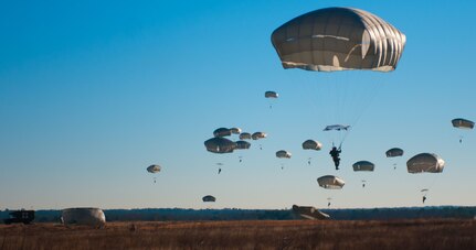 U.S. and foreign paratroopers jump from a C-130 during Operation Toy Drop XIX Dec., 9 at Luzon drop zone at Camp Mackall, N.C. During OTD, U.S. paratroopers have the chance to train with jumpmasters from other nations, learn about their training tactics, and expand their experience through working with partner nations. (U.S. Army Reserve photo by Spc. Tynisha L. Daniel)