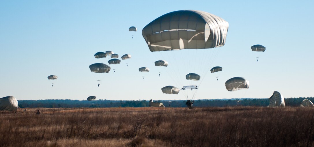 U.S. and foreign paratroopers jump from a C-130 during Operation Toy Drop XIX Dec., 9 at Luzon drop zone at Camp Mackall, N.C. During OTD, U.S. paratroopers have the chance to train with jumpmasters from other nations, learn about their training tactics, and expand their experience through working with partner nations. (U.S. Army Reserve photo by Spc. Tynisha L. Daniel)