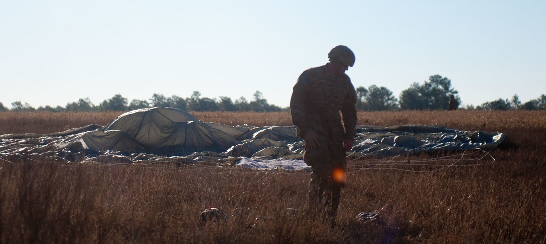 U.S. paratrooper, Sgt. Jared Jarvis representing C Battery, 3-319th squadron gathers his parachute after jumping from C-130 during Operation Toy Drop XIX Dec. 9 at Luzon drop zone at Camp Mackall, N.C. Sgt. Jarvis is one of 4,000 paratroopers participating in OTD XIX. OTD is the world’s largest annual joint and combined airborne operation and collective training. (U.S. Army Reserve photo by Spc. Tynisha L. Daniel)