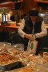 Deb Brooks, spouse of Col. Matthew Brooks 5th Bomb Wing commander, places cookies in a bag at the annual Airman Cookie drive at Minot Air Force Base, N.D., Dec. 9, 2016. Volunteers from the Officer’s Spouses Club organized cookies for 1,341 Team Minot Airmen. (U.S. Air Force photo/Airman 1st Class Jessica Weissman)