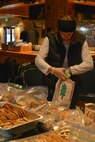 Deb Brooks, spouse of Col. Matthew Brooks 5th Bomb Wing commander, places cookies in a bag at the annual Airman Cookie drive at Minot Air Force Base, N.D., Dec. 9, 2016. Volunteers from the Officer’s Spouses Club organized cookies for 1,341 Team Minot Airmen. (U.S. Air Force photo/Airman 1st Class Jessica Weissman)