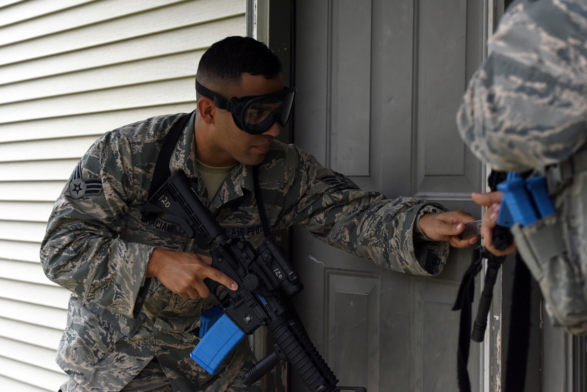 Senior Airman Xavier Graciana, a security forces specialist with the 180th Fighter Wing in Swanton, Ohio, prepares to breach a house during urban combat training Oct. 1, 2016, at the Maumee Police and Fire Training Center in Maumee, Ohio. Security Forces personnel conduct multiple annual training scenarios to maintain a high state of preparedness and readiness in the event of an emergency.