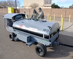 Senior Airman Ernesto Rodriguez, left, and Senior Airman Nicholas Koncar, both of the 58th Maintenance Squadron, fuel up the HandiFueler for the first time Dec. 2. The refueling tanker was purchased to help the unit improve the Aerospace Ground Equipment Flight’s aircraft support mission, saving the government both time and money.