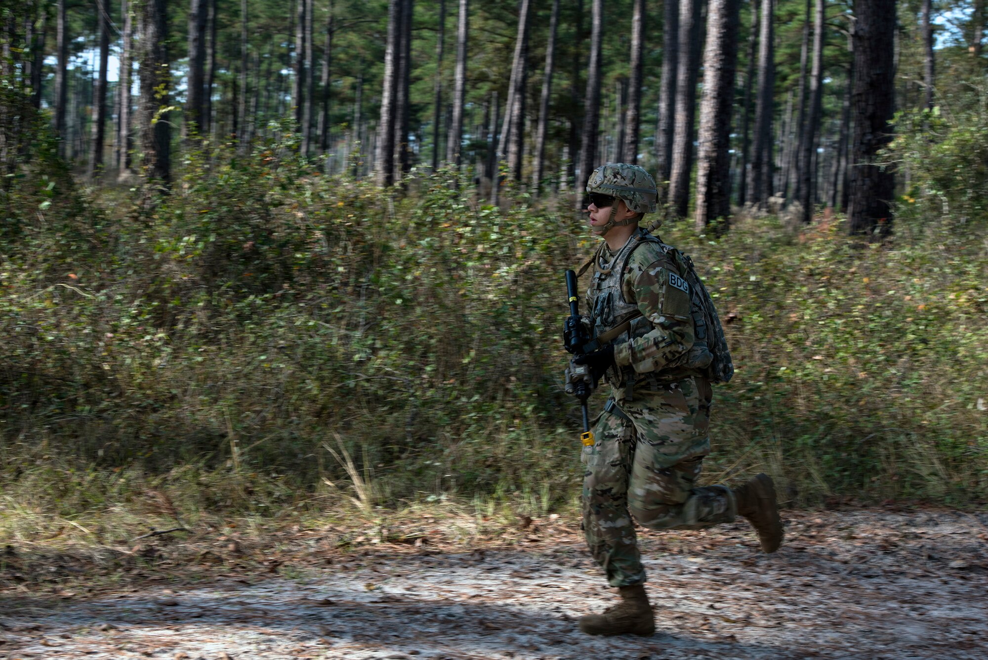 Airman 1st Class Tyris Smith, 824th Base Defense Squadron fire team member, runs to back up his counterparts during dismount training, Dec. 8, 2016, at Moody Air Force Base, Ga. Each member of the 824th BDS, also known as the Ghostwalkers, has the responsibility of being alert and providing security for others on the team. (U.S. Air Force photo by Airman 1st Class Greg Nash)